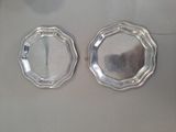 pair of silver plated coasters on a white surface