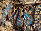 a very ornate blue and gold clock on the wall