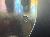 a close up of a metal fork with a screw on it