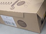 a cardboard box with a knife and a bottle of wine in it
