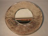 a silver plate with a mirror on it on a table