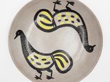 a plate with two birds painted on it