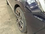 a close up of a car ' s front bumper with a denting on it