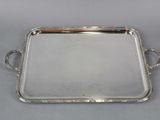 a silver tray with handles and handles on a table