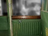 a green seat in the back of a green train car