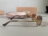 glasses are sitting on a table next to a pink purse