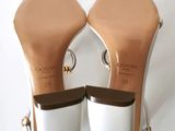 the back of a pair of women ' s shoes on a white surface