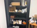 a black bookcase with many items on it in a room