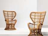two wicker chairs in a white room with a white wall