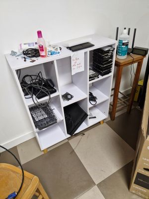 a white shelving with many items on it in a room