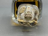 a bottle of perfume sitting on top of a table