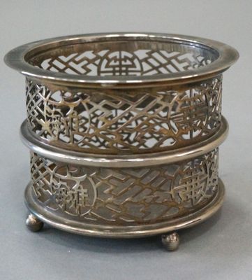 a silver plate with a design on it on a table