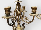 brass candelab with three candle holders on a white background