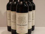 six bottles of red wine are lined up on a table