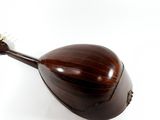 a wooden instrument that is sitting on a white surface