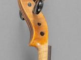 a close up of a violin on a gray background