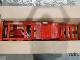 a cardboard box with a red bench inside of it