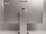 the back of a computer monitor with a blue button on it