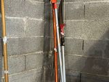 a red and silver scooter leaning against a brick wall