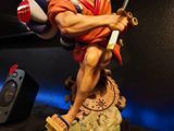 a figurine of a man holding a sword and a ball