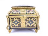 a gold and black box with flowers on it