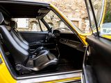 a yellow car with a black seat in the back of it