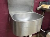 a stainless steel sink in a public restroom