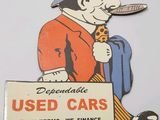 a sign that says used cars with a man smoking a cigarette