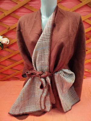 an image of a mannequin wearing a brown and white plaid shawl