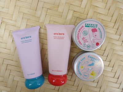 three different types of skin care products on a woven surface