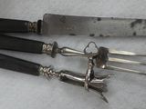 three knives and a knife holder on a table