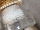 a glass jar with a small amount of sugar in it