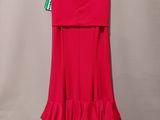 a red dress hanging on a hanger against a wall