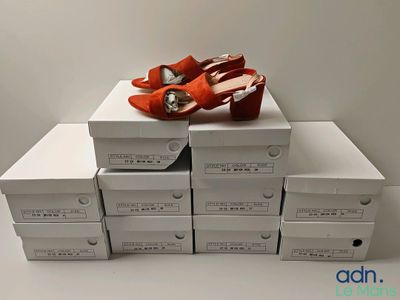 several boxes of shoes are stacked on top of each other
