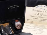 a black box with a watch and a certificate in it