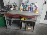 a workbench with a lot of bottles and cans on it