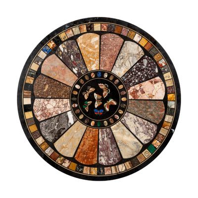 a round marble table with many different colors and designs