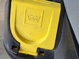a close up of a parking meter with a yellow button