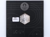 a picture of a silver coin with a picture of a man on it