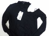the shirt is black and has a white tag on it