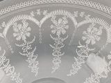 a glass bowl with a design on it on a table