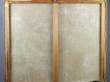 an old wooden easel with a canvas on top of it on a gray background