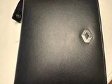 a black leather wallet with a silver logo on the front