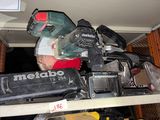 a pile of tools on top of a shelf in a room