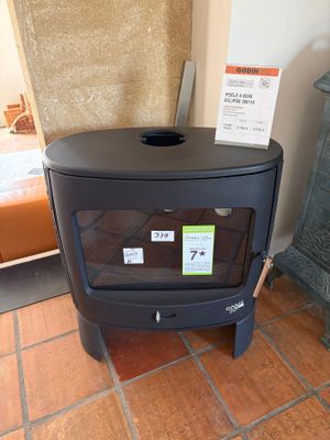 a black stove in the corner of a room