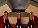 three bottles of wine sitting next to each other on a table