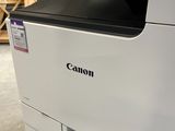 a close up of a canon printer sitting in a warehouse