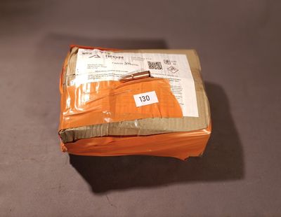 an orange package wrapped in plastic sitting on a table