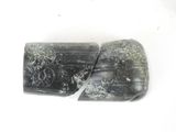two pieces of black and white marble on a white surface