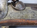a close up of a gun that is on display